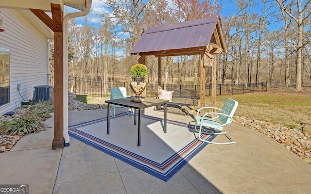 view of patio with a fenced backyard and central AC unit