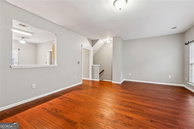 interior space featuring visible vents, baseboards, and wood finished floors