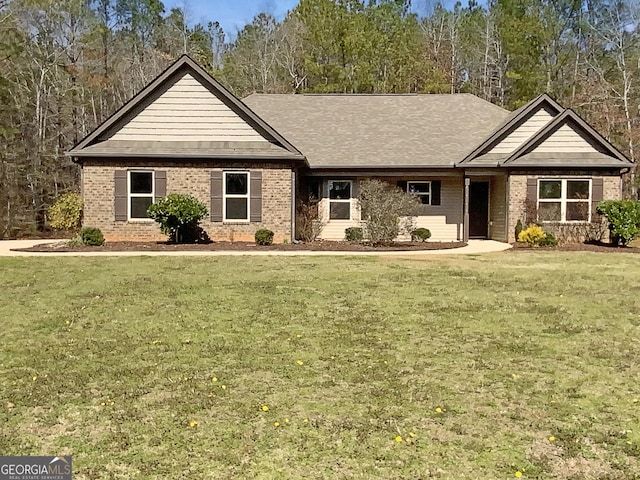 single story home featuring brick siding and a front lawn