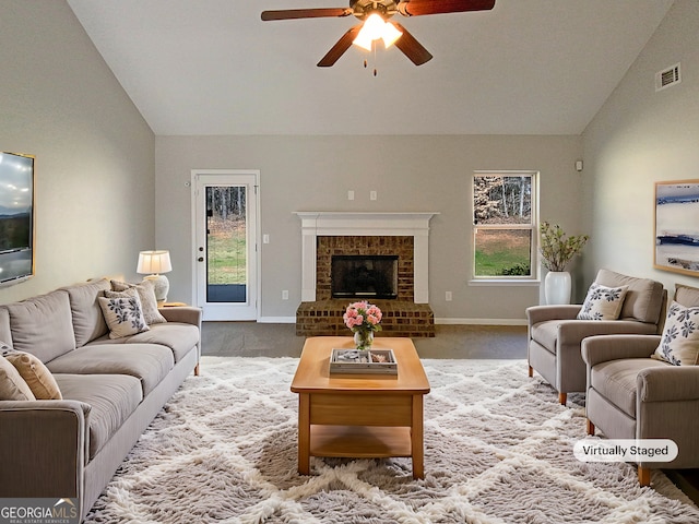 carpeted living room featuring a ceiling fan, lofted ceiling, visible vents, and a fireplace