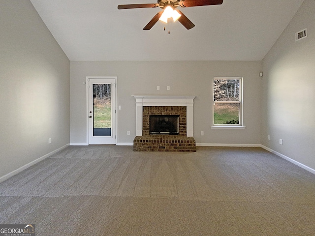 unfurnished living room with lofted ceiling, a fireplace, visible vents, and baseboards