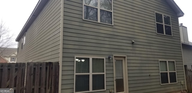 view of side of home with fence