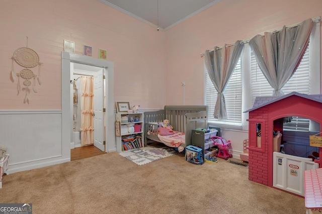 rec room with light carpet, crown molding, and a high ceiling