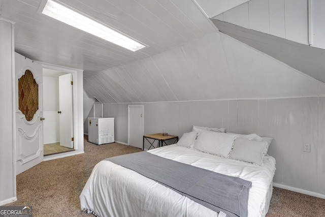 bedroom with light carpet, vaulted ceiling, and fridge