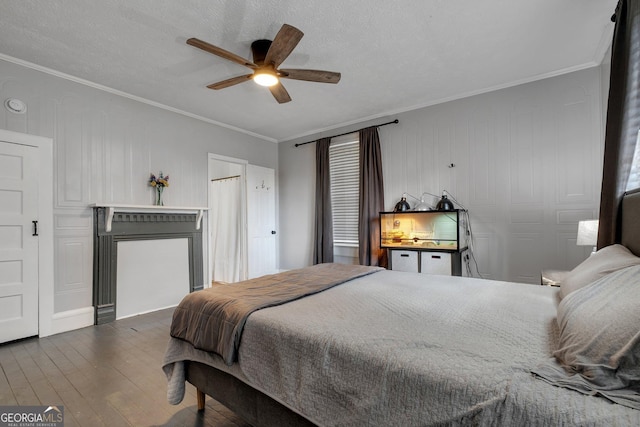 bedroom featuring ceiling fan, ornamental molding, and dark wood finished floors