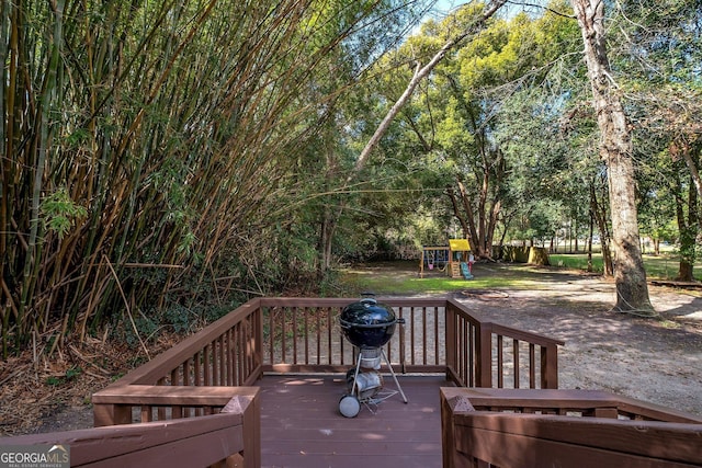 deck featuring area for grilling and a playground