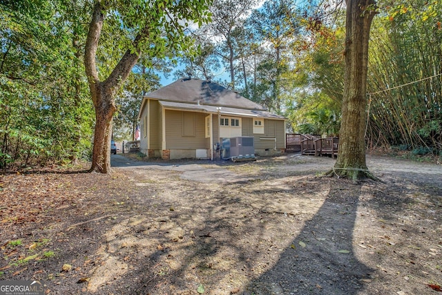 view of front of house with crawl space, central AC, and a wooden deck