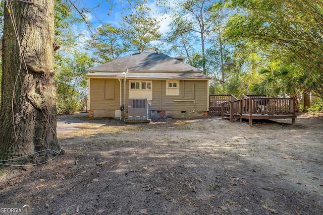 rear view of house featuring cooling unit, crawl space, and a wooden deck