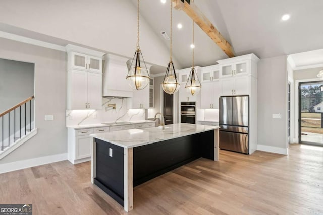 kitchen featuring hanging light fixtures, white cabinetry, glass insert cabinets, and stainless steel appliances