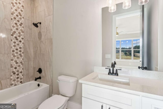 bathroom featuring toilet, ceiling fan, shower / washtub combination, and vanity