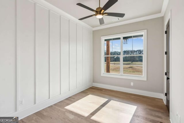 unfurnished bedroom with ornamental molding, light wood-style floors, and baseboards