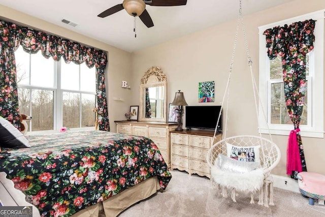 carpeted bedroom featuring visible vents