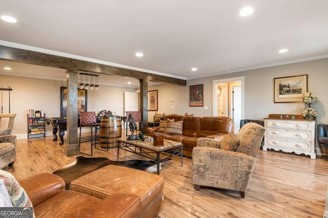 living area featuring ornamental molding, light wood-style flooring, a wood stove, and recessed lighting