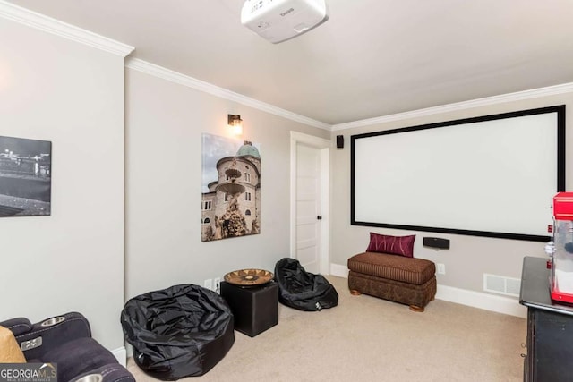 cinema room featuring baseboards, visible vents, ornamental molding, and light colored carpet