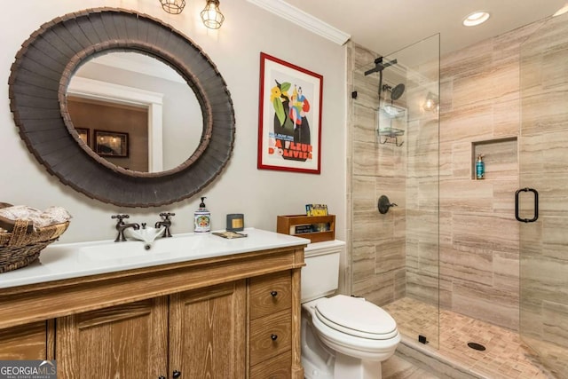 bathroom with vanity, ornamental molding, a shower stall, and toilet