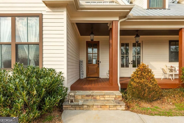 property entrance featuring metal roof, a porch, and a standing seam roof