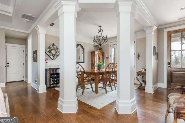 dining space featuring decorative columns, visible vents, and dark wood finished floors