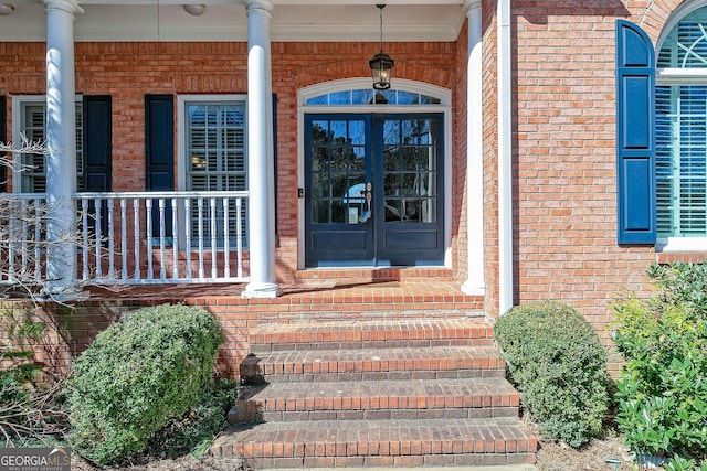 property entrance with french doors and brick siding