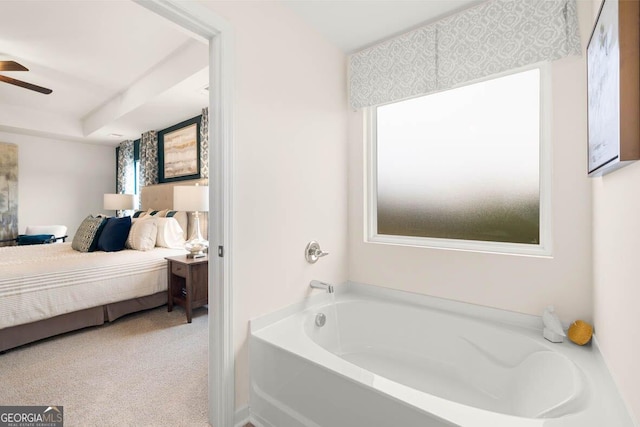 bathroom featuring a ceiling fan, a garden tub, and ensuite bath