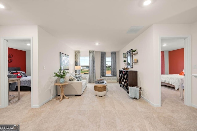 living area with recessed lighting, baseboards, and light colored carpet