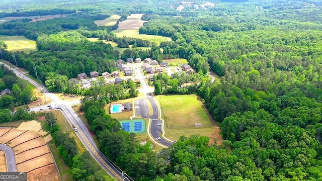 birds eye view of property featuring a wooded view