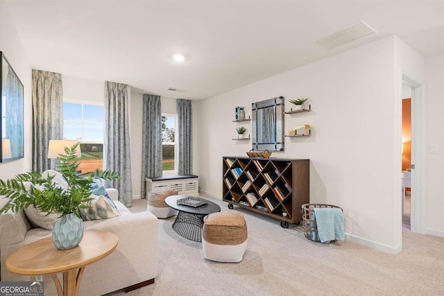 sitting room with baseboards, visible vents, and carpet flooring