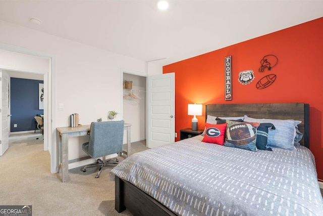 bedroom featuring light carpet and a closet