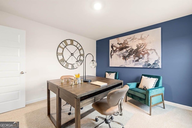 home office with baseboards and light colored carpet