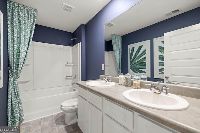 bathroom with shower / tub combo with curtain, visible vents, and a sink