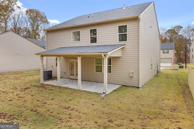 rear view of property featuring a yard, a patio area, cooling unit, and fence