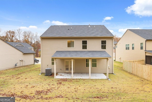 rear view of house featuring central AC, a lawn, a patio area, and fence