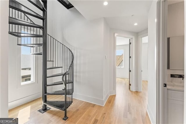 staircase with recessed lighting, wood finished floors, and baseboards