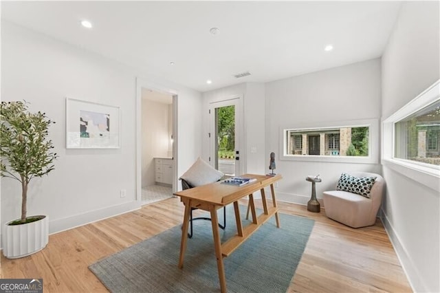 office space with light wood-type flooring, visible vents, baseboards, and recessed lighting