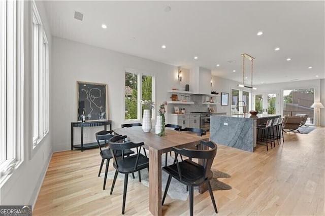 dining area with visible vents, light wood finished floors, a wealth of natural light, and recessed lighting