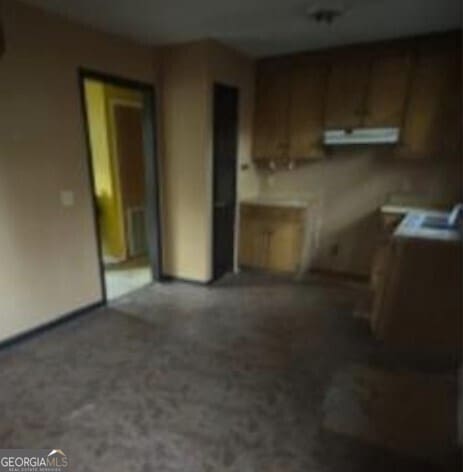 kitchen with brown cabinets and exhaust hood