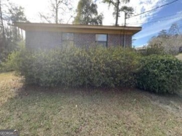 view of property exterior featuring a lawn