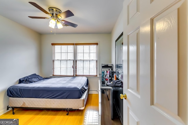 bedroom with a ceiling fan and wood finished floors