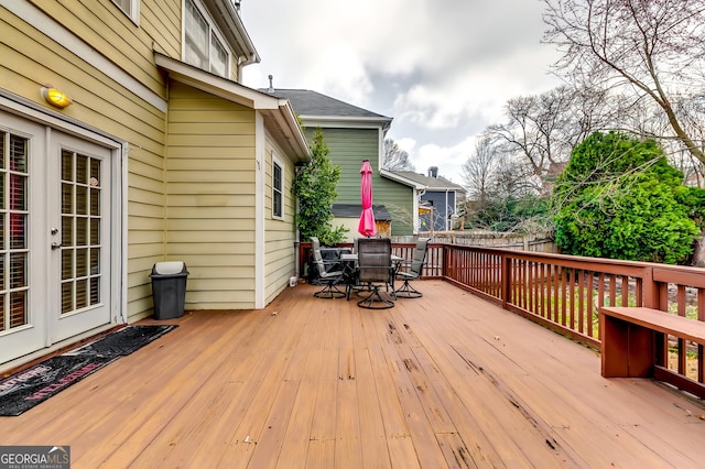 wooden deck with french doors and outdoor dining space