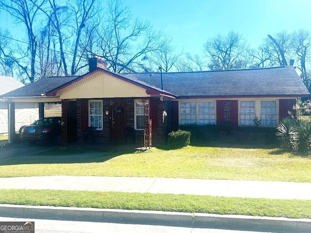 ranch-style home featuring roof with shingles, a chimney, and a front lawn