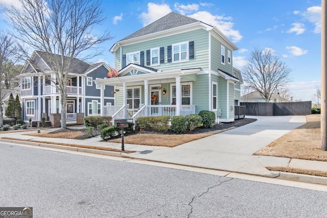 view of front of property with fence and a porch