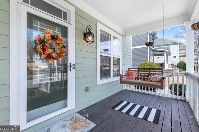 wooden terrace featuring covered porch