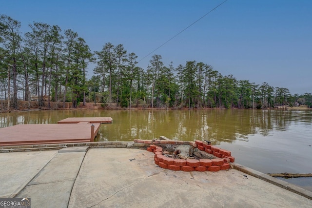 view of dock featuring a water view and a fire pit