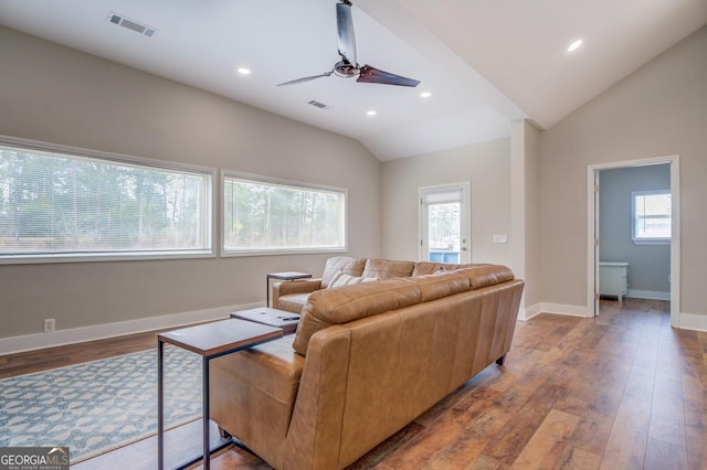 living room with lofted ceiling, recessed lighting, visible vents, wood finished floors, and baseboards