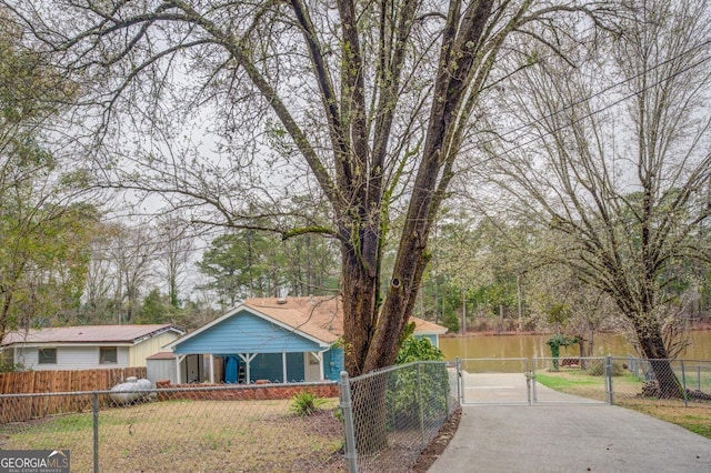 ranch-style house with a fenced front yard and a gate