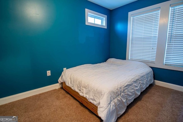 carpeted bedroom featuring baseboards