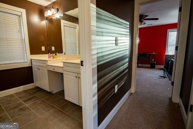 bathroom featuring tile patterned floors, ceiling fan, baseboards, and vanity