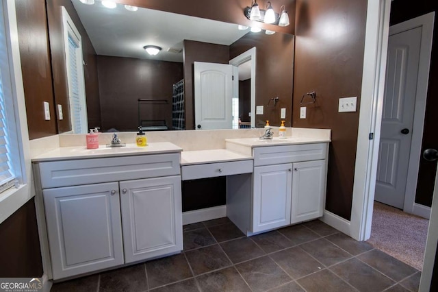 full bathroom with double vanity, baseboards, a sink, and tile patterned floors