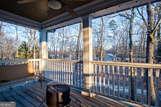 wooden terrace featuring ceiling fan