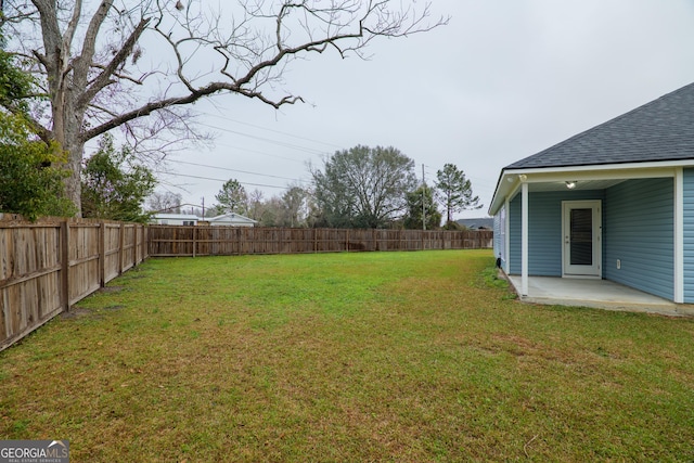 view of yard with a fenced backyard and a patio