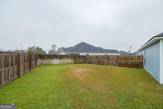 view of yard with a fenced backyard